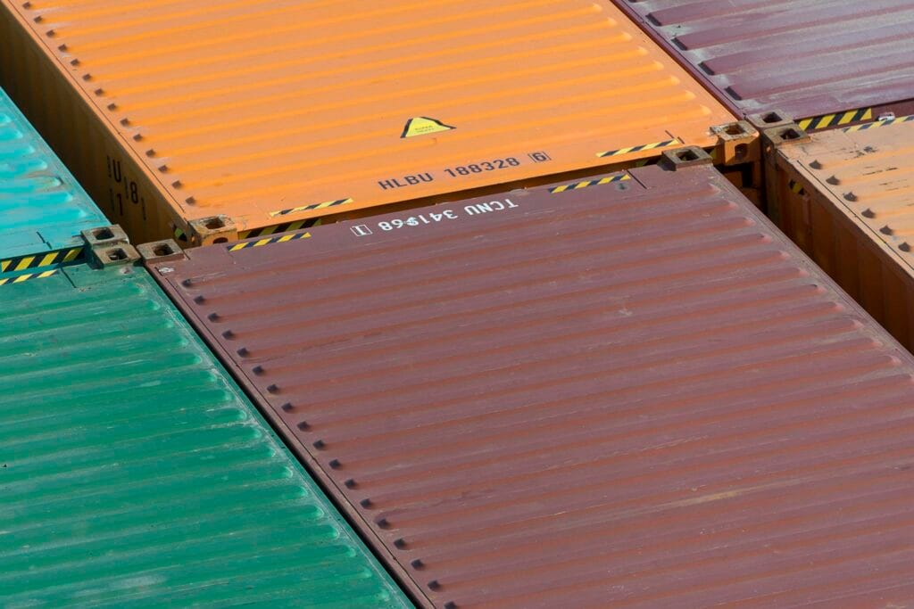 Aerial view of vibrant cargo containers arranged in a pattern, emphasizing logistics and transportation.